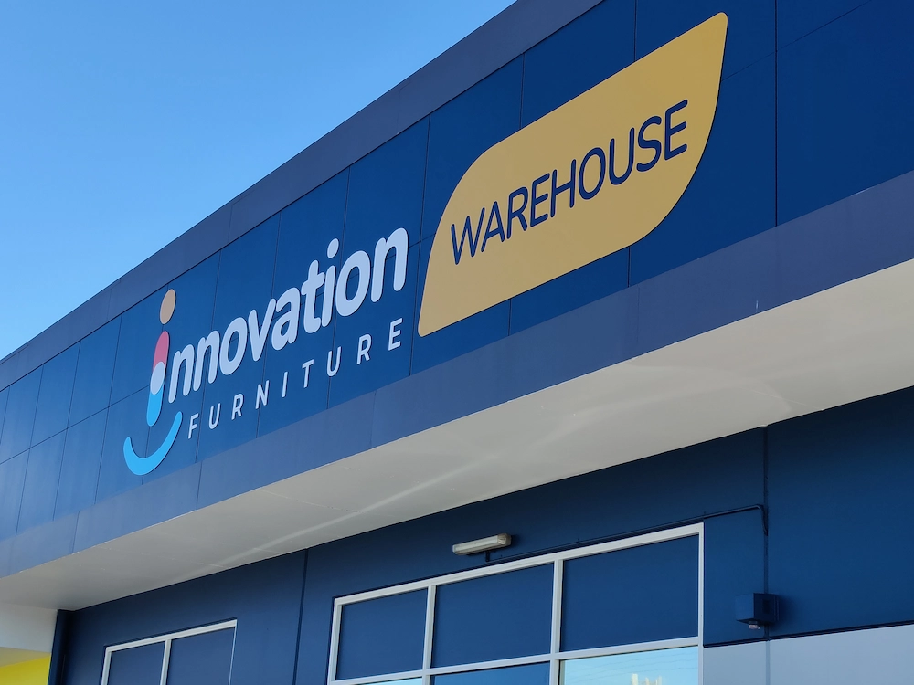 Non-illuminated dimensional 3D acrylic letters and fabricated building logo on blue cladding